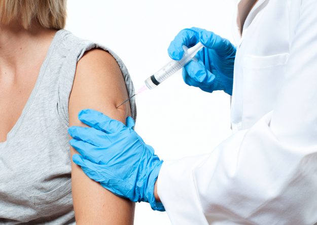 Vaccination. Doctor Injecting Flu Vaccine To Patient’s Arm.