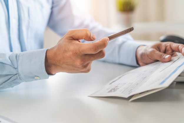 Close Up Hand Of Person Shopping In Mobile And Paying Via Intern